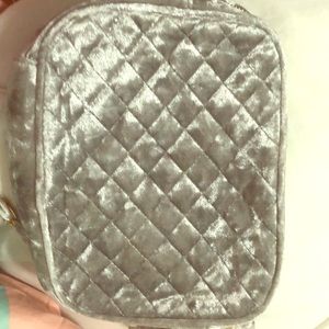 A silver purse with detachable strap